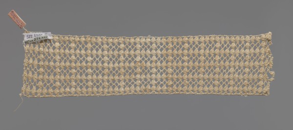 Fragment of crocheted lace — section of a belt, cream-colored, with motifs of semicircular shells