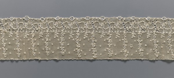Fragment of lace, lace, ornament: continuous vertical twigs at the top with points between them; at
