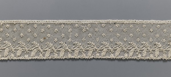 Fragment of lace, Alençon lace, decorated with small twigs in projections and a tendril with