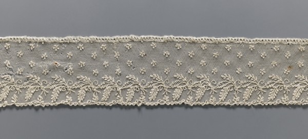 Fragment of lace, Alençon lace, decorated with small twigs in projections and a tendril with