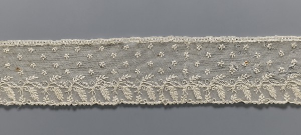Fragment of lace, Alençon lace decorated with small twigs in projections and a tendril with