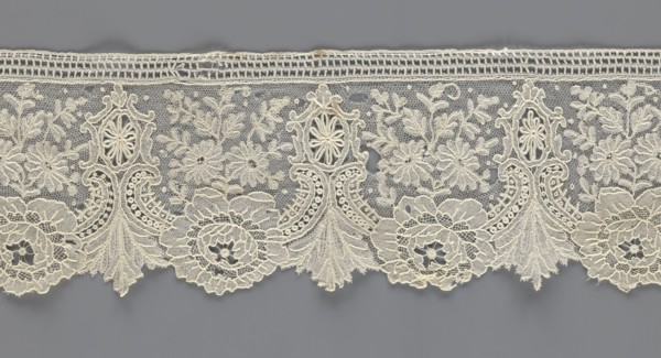 Lace fragment;, purchased provenance noted; lace with plant ornaments. Serrated on one side, with a