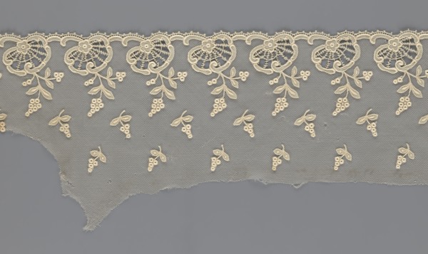 Fragment of lace, lace with plant ornaments, slightly serrated lower edge, shell motifs with