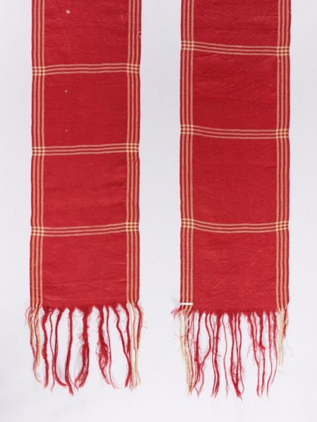 Belt; woolen; red with motifs of three narrow cream-colored trails spaced lengthwise and crosswise