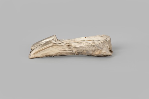 Flat women's slippers of white satin. Flat-cut toe, symmetrical soles of thin leather. The endpaper