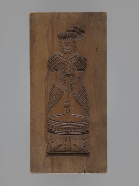 Double-sided gingerbread mould. Obverse: female figure in a long, patterned, richly decorated