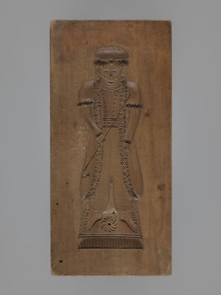 Double-sided gingerbread mould. Obverse: female figure in a long, patterned, richly decorated