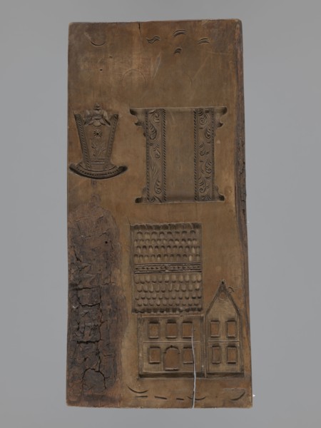 Double-sided gingerbread mould. Obverse: figure of a bearded man in patterned clothes, richly