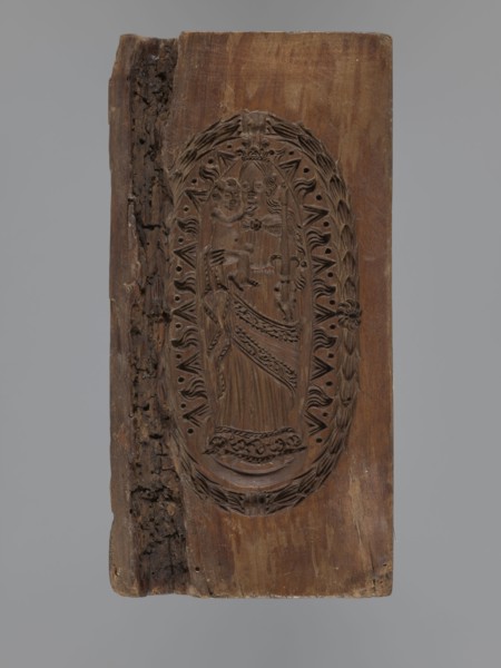 Double-sided gingerbread mould. Obverse: Madonna and Child with a crown, in a long patterned dress,