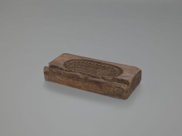 Double-sided gingerbread mould. Obverse: Madonna and Child—Madonna wearing a crown, in a long