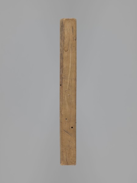 Double-sided gingerbread form. Oblong rectangular shape; obverse: female figure in a long patterned