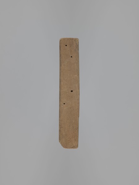 Double-sided gingerbread form. Obverse: female figure in a long patterned dress and a hat. Reverse: