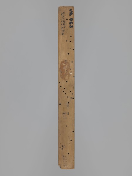 Double-sided gingerbread form. Obverse: female figure in a hat and a long patterned dress. Reverse: