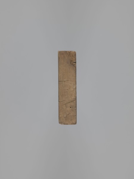 Double-sided gingerbread form. Obverse: female figure in a hat and long patterned dress; Reverse: