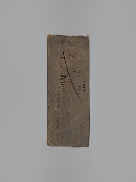 Double-sided gingerbread mold. Obverse: male figure in a high hat and a fur-lined jacket seated on