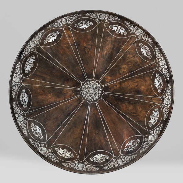 Table with round tilting top on a shaft composed in the middle of three balusters, forked at the
