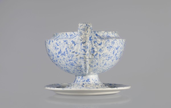 Semi-ovoidal vase on a low pedestal base with sharply broken edges and tapering concave profile.