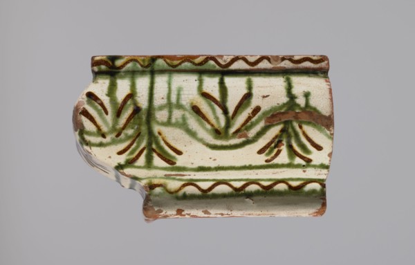 Cornice tile fragments 4, painted with a wavy twirl pattern; tile cullet; stoves; plant
