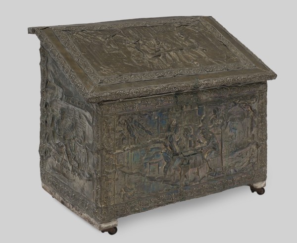 Box with straight walls and a diagonally sloping lid, covered with embossed brass sheet depicting