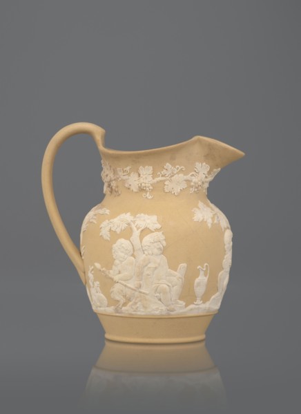 Oinochoe jug, cane ware pottery, beige-sand with a ribbon handle; around the belly, white reliefs: