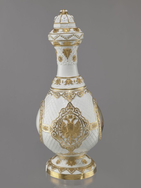 Bottle-shaped vase with a domed lid. Embossed and colorfully painted decoration. Four medallions