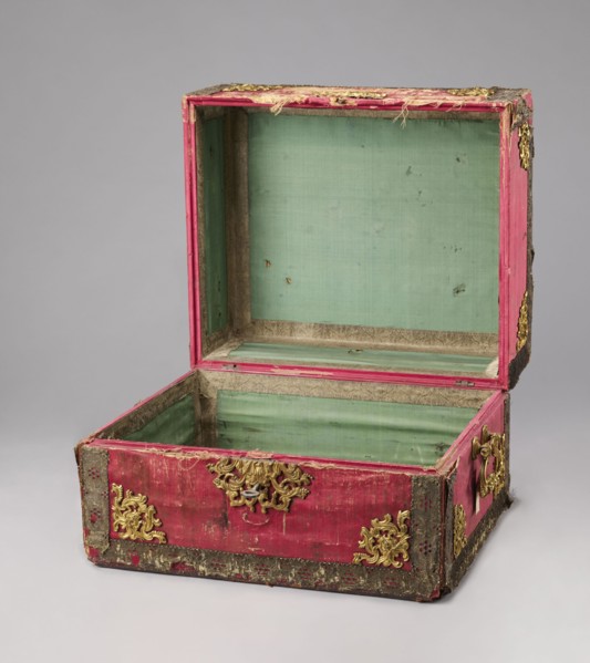 Casket case. The case is a rectangular wooden box covered with red velvet, with gold thread