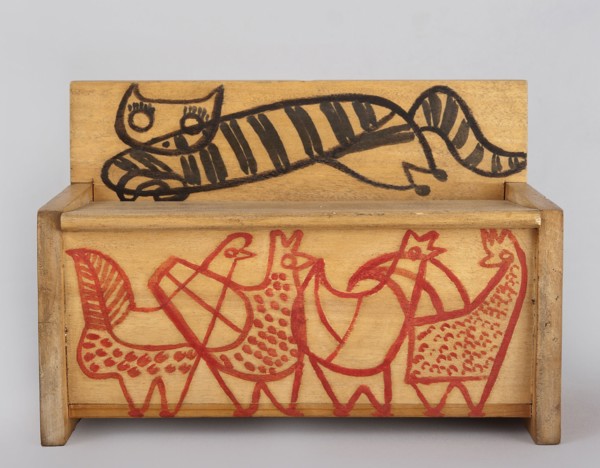 A wooden bench from a set of doll furniture. Wooden bench with a box closed by a flap forming a