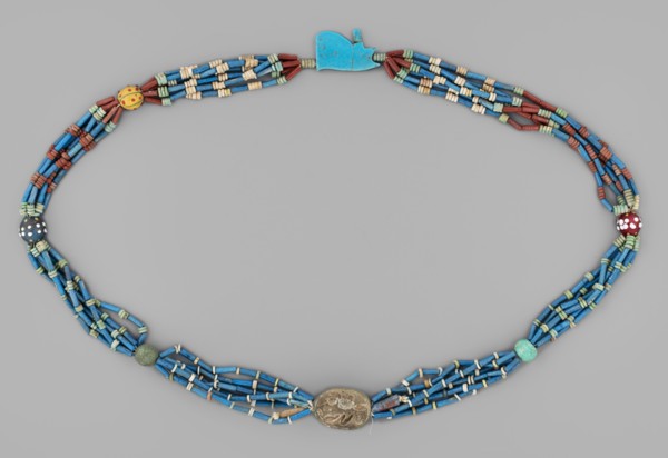 Necklace with a scarab and an udjat eye. Necklace composed of six rows of faience tubular and