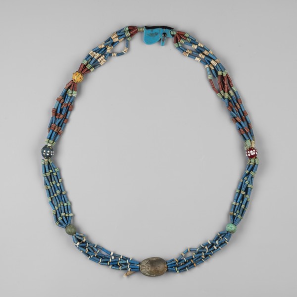 Necklace with a scarab and an udjat eye. Necklace composed of six rows of faience tubular and