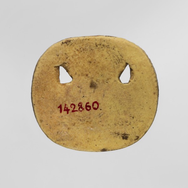 Amulet — plaque with the head of the god Bes. Amulet in the form of an oval, serrated, openwork