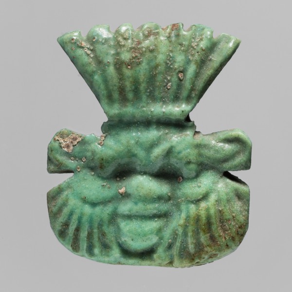 Amulet — plaque with the head of the god Bes;, Amulet in the form of a plaque with a relief