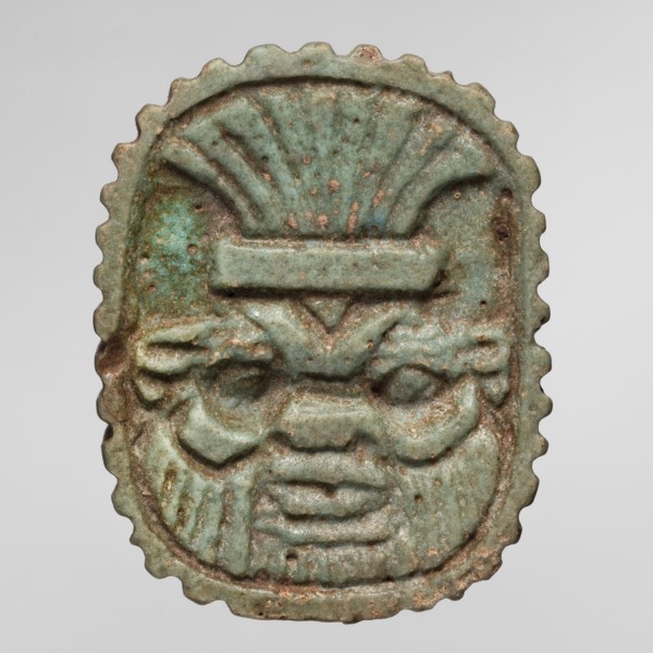 Amulet plaque with the head of the god Bes; plaque amulet, Egyptian deity Bes, wearing crowns. Late