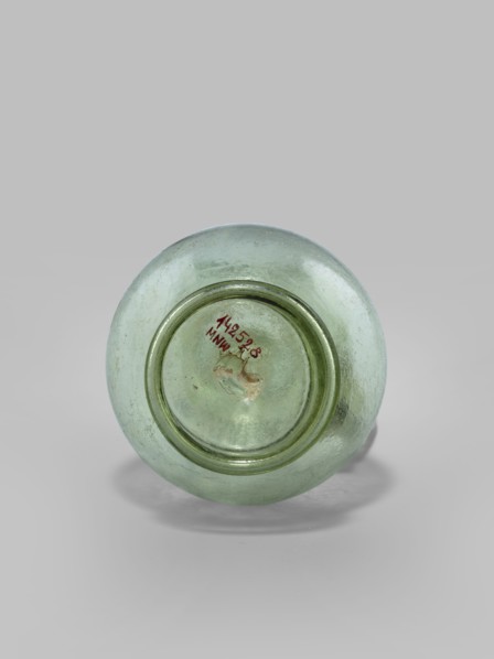 Oinochoe. Transparent, light green glass. Spherical belly on a foot with a clearance, created by