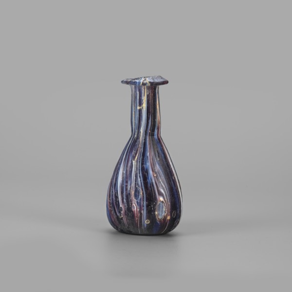 Unguentarium, unknown eastern workshop, translucent glass, mosaic: blue-violet-white. Pear-shaped
