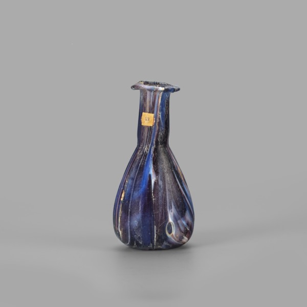 Unguentarium, unknown eastern workshop, translucent glass mosaic blue-violet-white. Pear-shaped