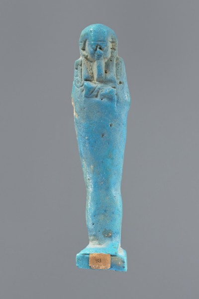 Ushabti, Mummy-shaped figurine, standing on a base, back supported by a pillar/pilaster. Arms