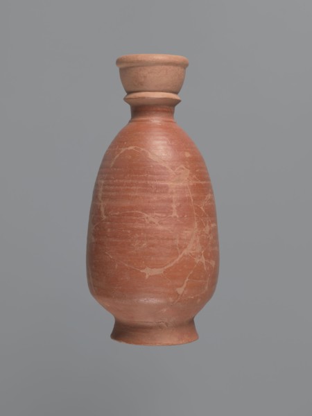 Bottle, unknown Aswan workshop; baggy-shaped bottle without a preserved spout. The neck widens