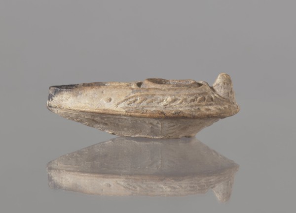 Oil lamp, unknown Palestinian workshop. Oval lamp with conical handle. Large olive opening