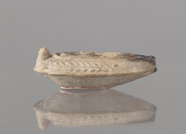 Oil lamp, unknown Palestinian workshop. Oval lamp with conical handle. Large olive opening
