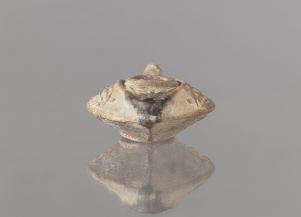 Oil lamp, unknown Palestinian workshop. Islamic art, Arabic culture. Oval lamp with conical handle.