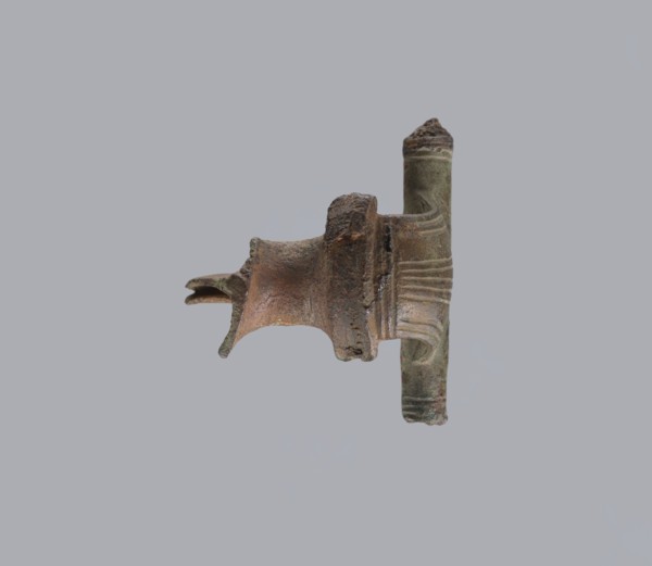 Brooch with a crossbar. Brooch with a bow made of a wide, slightly curved band decorated with
