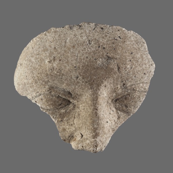 Fragment of a stucco mask; upper part of a sarcophagus mask showing forehead, eyes and nose.