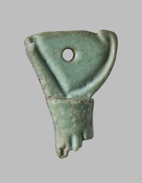Amulet in the shape of a crown of Lower Egypt. Between the back of the crown and the rod, a plane