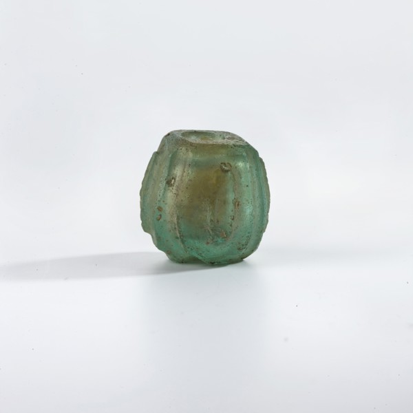 Bottle, Islamic, Persian; blue-green glass bottle decorated with small almond-shaped ovals in an