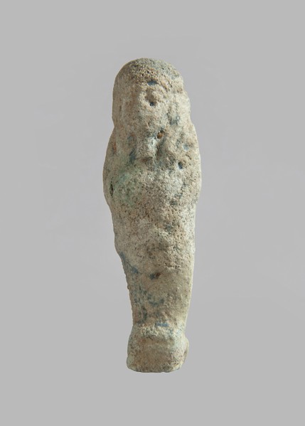 Ushabti, carelessly made figurine with schematic facial features, in a narrow wig revealing the