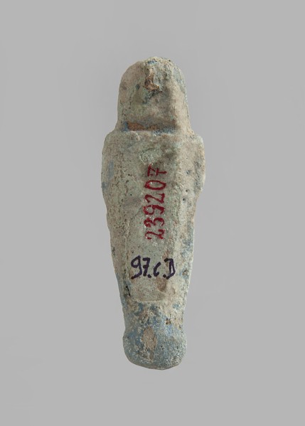 Ushabti. Carelessly made figurine with schematic facial features, in a narrow wig revealing the
