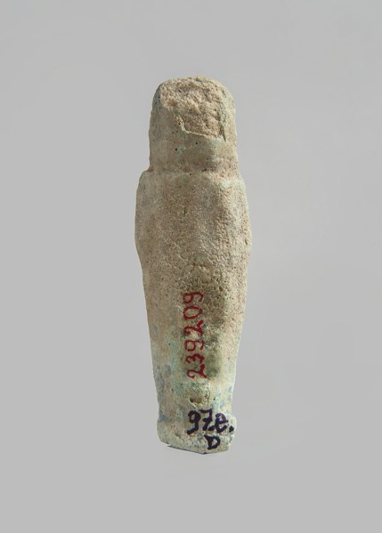 Ushabti. Carelessly made figurine with schematic facial features, in a narrow wig revealing the