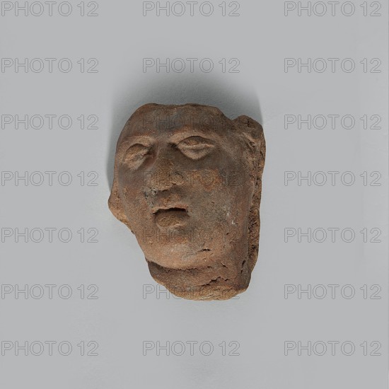 Fragment of the head of a terracotta female figurine. Fragmentarily preserved head depicting a