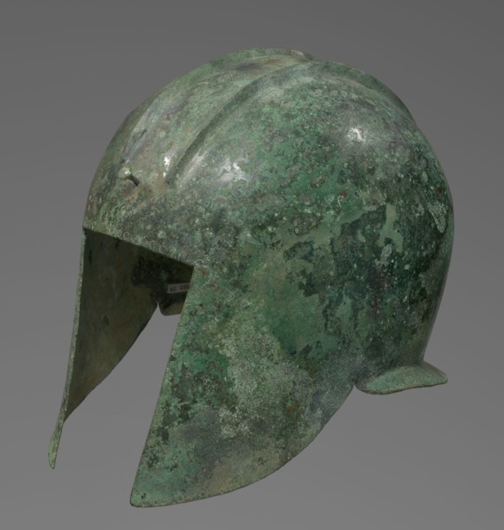 Bronze helmet with rectilinear cutouts for the eyes, nose, mouth, and chin; two prominent