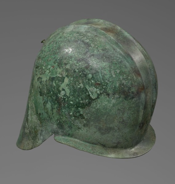 Bronze helmet with rectilinear cutouts for the eyes, nose, mouth, and chin; the helmet has two